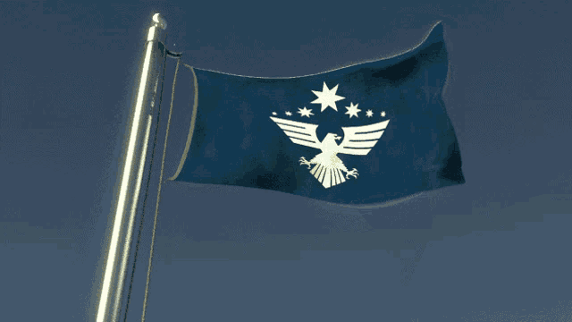 a blue flag with an eagle on it is flying in the wind