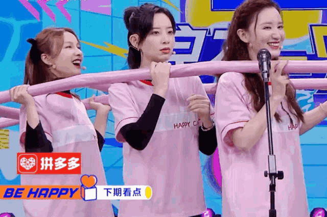 three girls wearing pink shirts that say be happy on them
