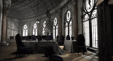a dining room with tables and chairs and a large window