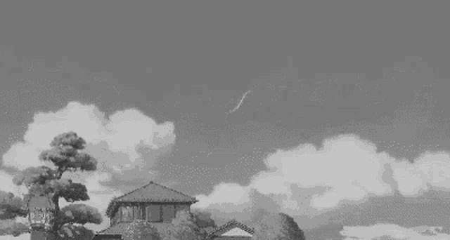 a black and white photo of a house with a tree in front of it and a shooting star in the sky .