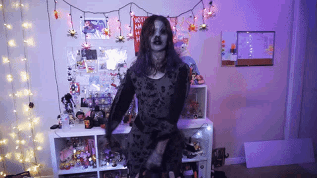 a girl in a zombie costume is standing in front of a sign that says not a man