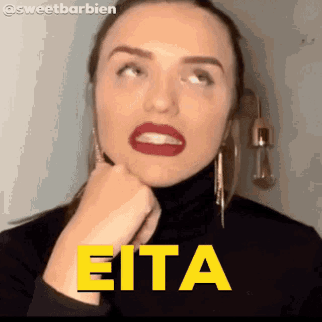 a woman in a black turtleneck is making a funny face with the word eita written in yellow