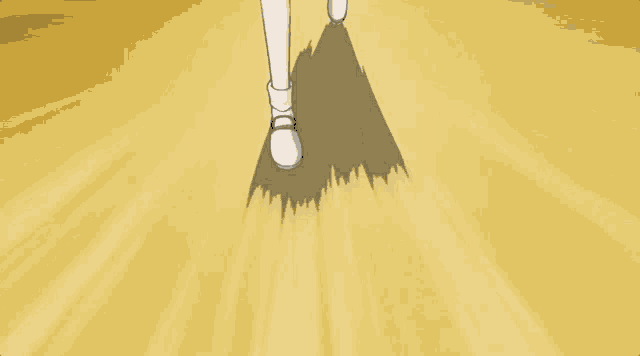 a person 's foot is casting a shadow on a yellow surface