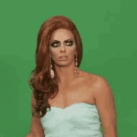 a woman in a strapless white dress is making a funny face .