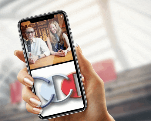 a woman holds a cell phone with a picture of a man and woman on it