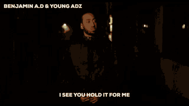 a man is standing in the dark with the words i see you hold it for me above him