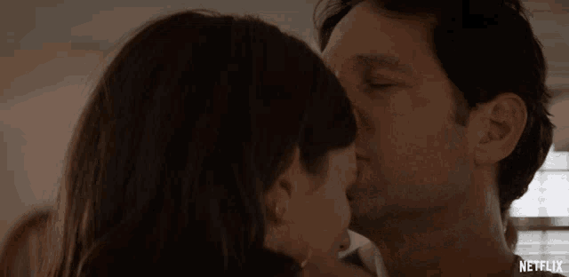 a man and a woman kissing with netflix written on the bottom