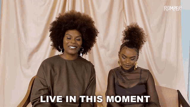 two women sitting next to each other with the words " live in this moment " on the bottom