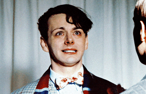 a man wearing a bow tie and a plaid jacket