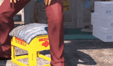 a yellow coran stool sits on the ground in front of a building