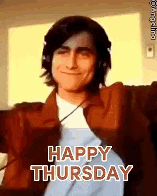 a man wearing headphones is smiling and saying happy thursday