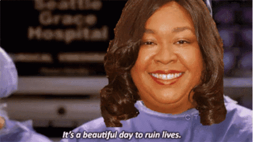 a woman is smiling in front of a seattle grace hospital sign