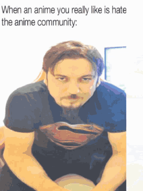 a man with a beard wearing a superman t-shirt