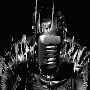 a black and white photo of a metal batman statue