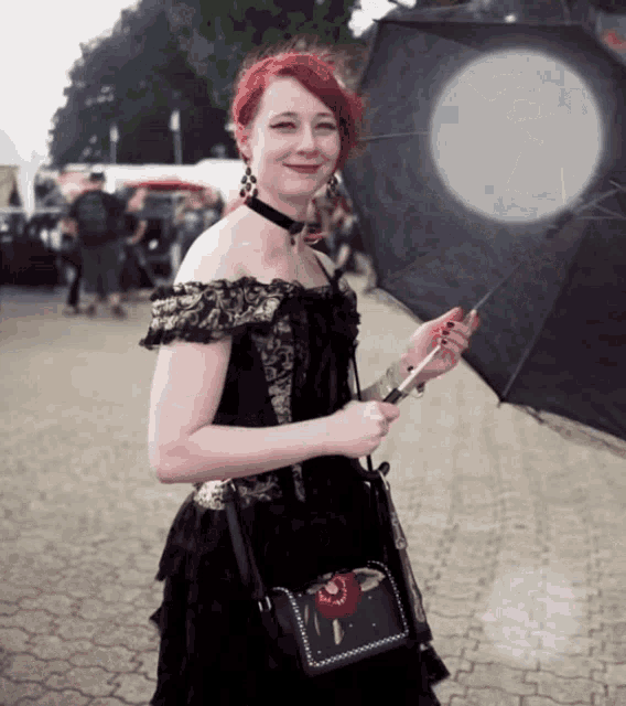 a woman with red hair is holding an umbrella
