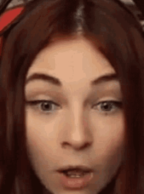 a close up of a woman 's face with a surprised expression .
