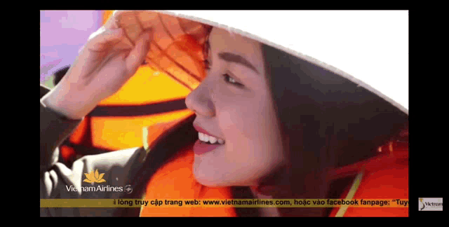 a woman wearing a hat with vietnam airlines on the bottom