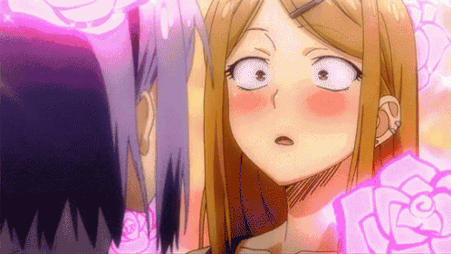 a man and a woman are standing next to each other and looking at each other with their eyes closed .