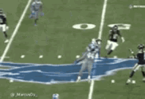 a football player with the number 5 on his jersey is being tackled by another player