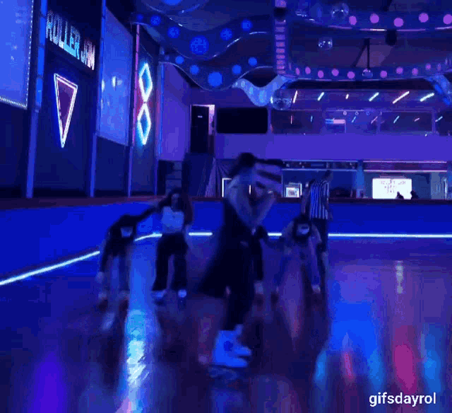 a roller rink with a sign that says roller on the wall