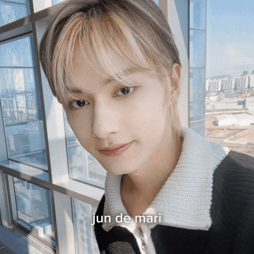 a close up of a person 's face with the name jun de mari on it