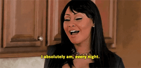 a woman is standing in a kitchen and saying `` i absolutely am every night . ''