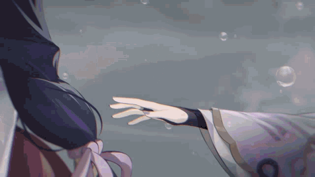 a man and a woman are holding hands in the rain .