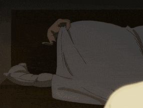 a person laying on their back with their head on a pillow in the dark