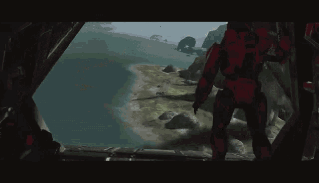 a man in a red suit is standing in a dark room