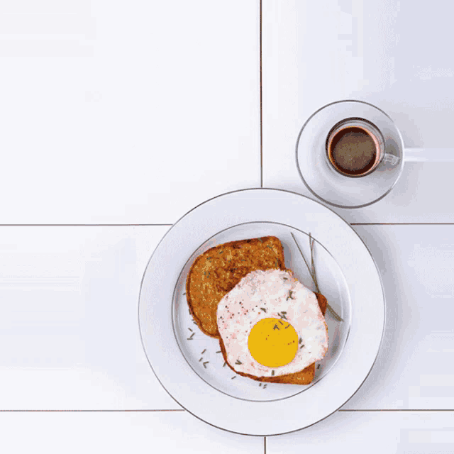 a white plate with a fried egg and toast next to a cup of coffee that says puray