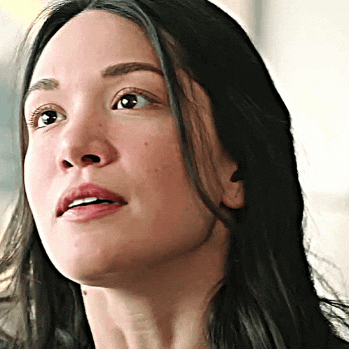 a close up of a woman 's face with a smile on her face