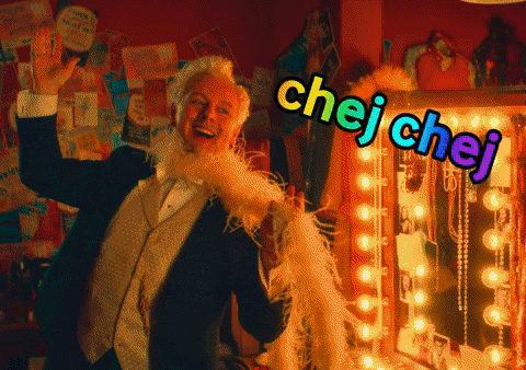 a man in a tuxedo stands in front of a mirror with chej chej written on the bottom