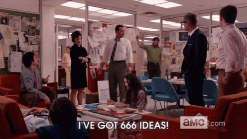 a group of people are gathered around a table with the words " i 've got 666 ideas " on the screen