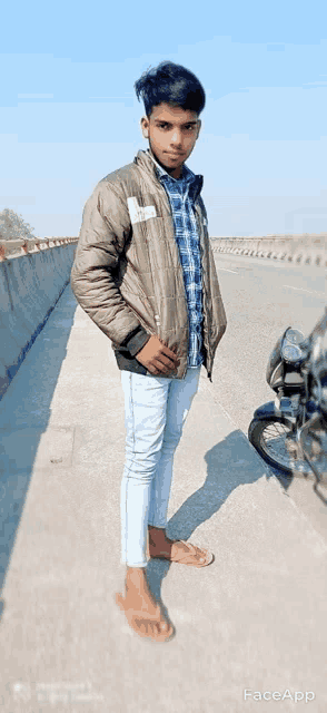 a young man is standing next to a motorcycle on a sidewalk