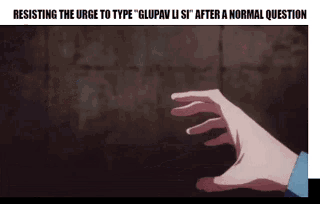 a person 's hand is reaching out towards a brick wall .