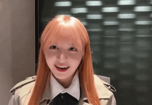 a girl with long blonde hair is wearing a trench coat and a white shirt