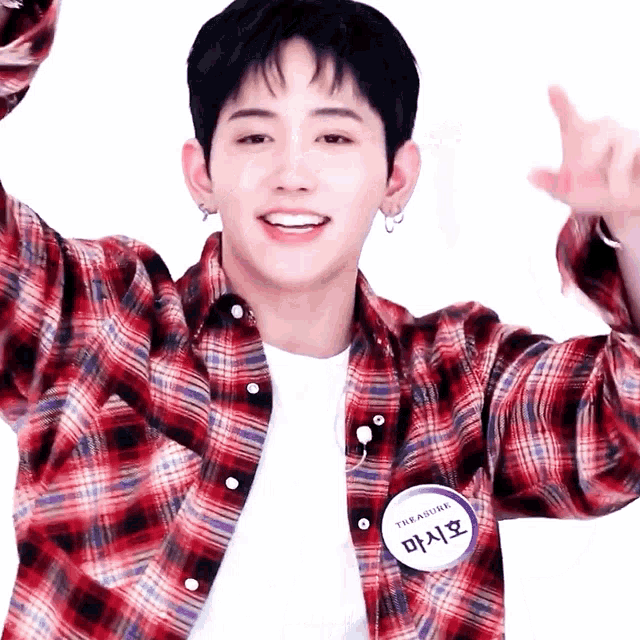 a young man wearing a plaid shirt has a name tag that says the treasure