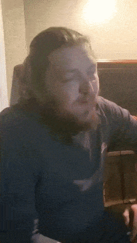a man with a beard is wearing a blue shirt with the word eagle on it