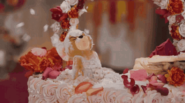 a cake with flowers and a figurine on top that says ' i love you ' on it