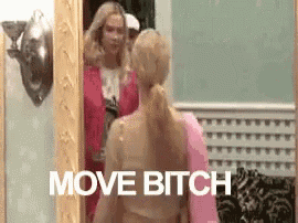 a woman is standing in front of a mirror with the words `` move bitch '' above her .