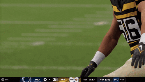 a football player wearing a black and yellow striped jersey with the number 13 on it