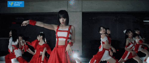 a group of girls are dancing in front of a banner that says upfront works