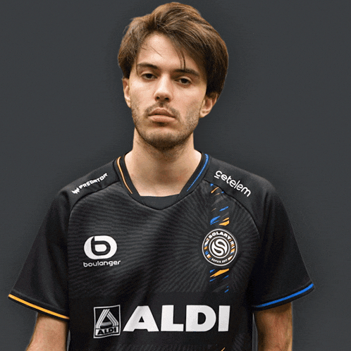 a man wearing a black shirt with aldi on the front