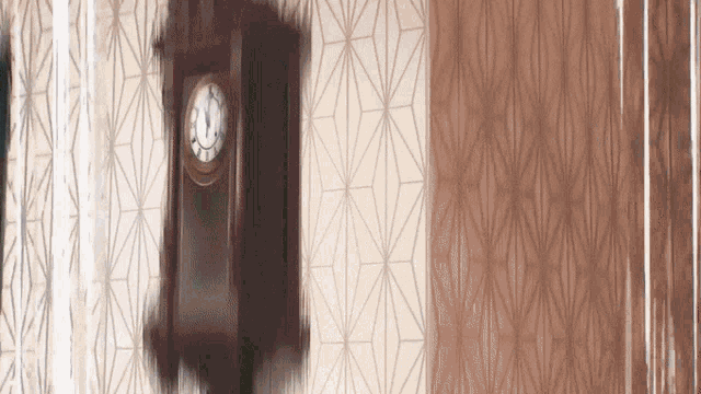a clock hanging on a wall with a geometric pattern on the wall