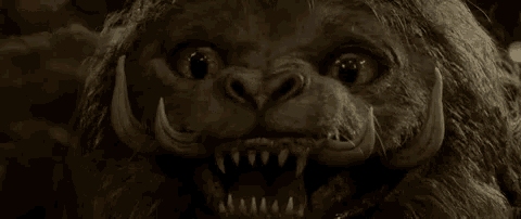 a close up of a monster 's face with sharp teeth .