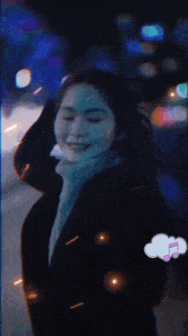 a woman 's face is glowing in the dark with a music note in a thought bubble
