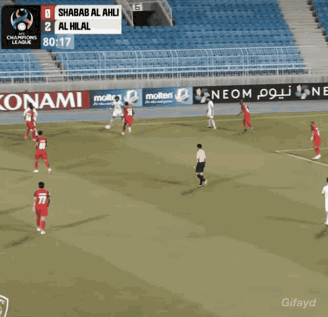a soccer game is being played in a stadium with advertisements for molten and konami
