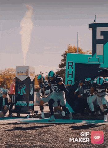 a group of football players are running on a field with a sign that says builders on it