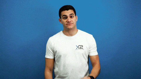 a man wearing a white shirt that says x2 on the front