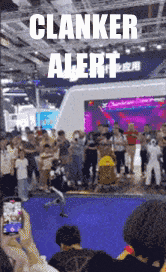 a crowd of people are gathered in front of a stage with the words clanker alert on it